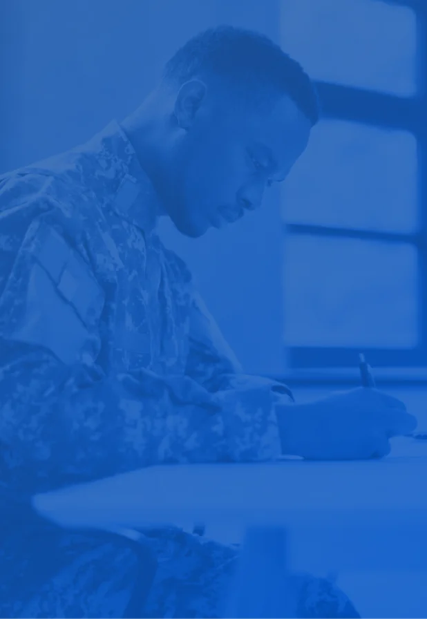 a soldier writing on a paper