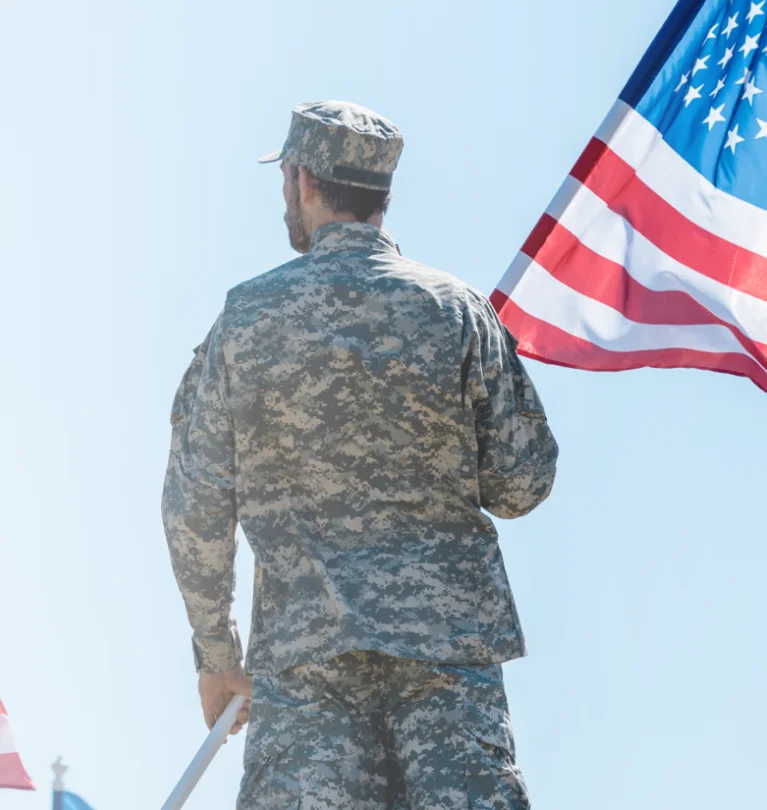 a man in military uniform holding a flag