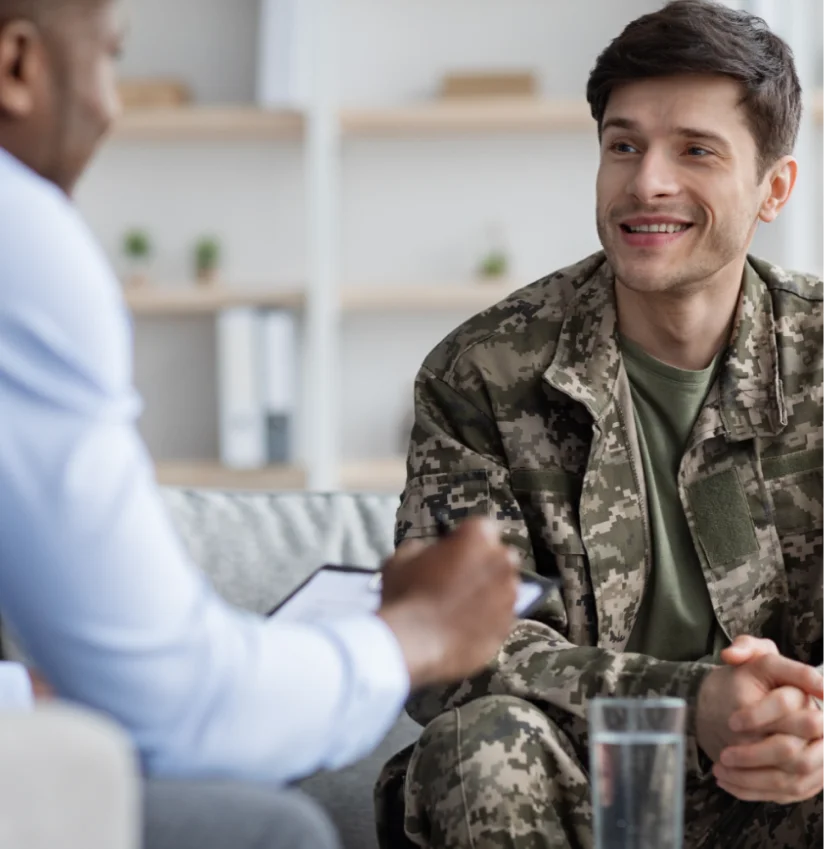 a man in military uniform talking to another man