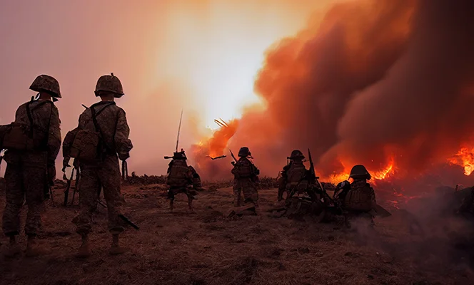 a group of soldiers in a field with smoke and fire