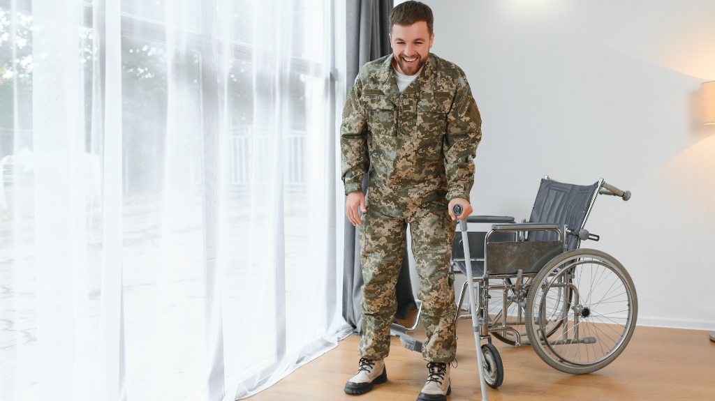 Happy soldier in military uniform getting up from wheelchair