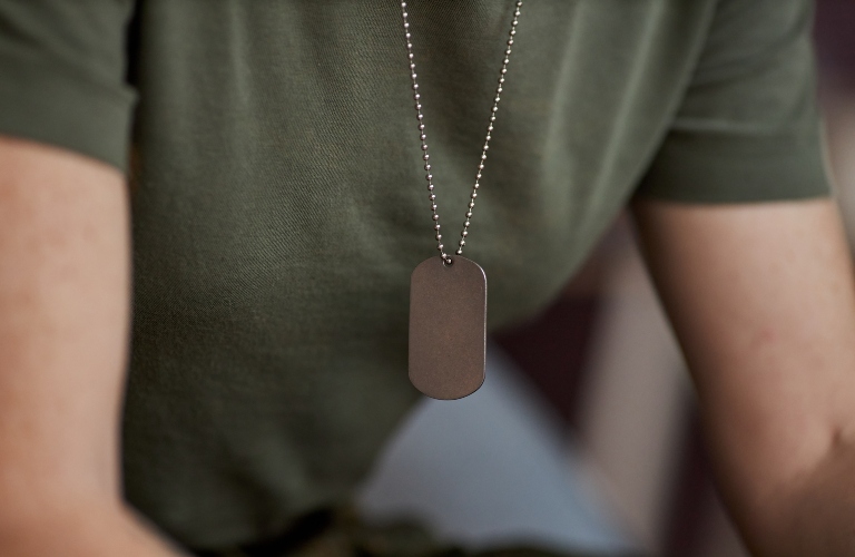unrecognizable military woman with focus on tag necklace