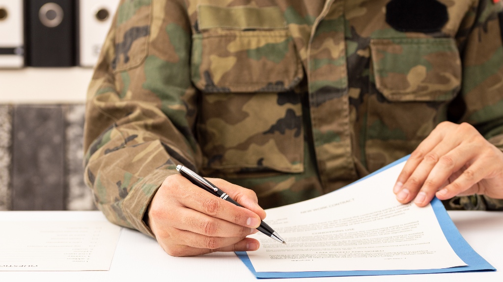 veteran is signing document