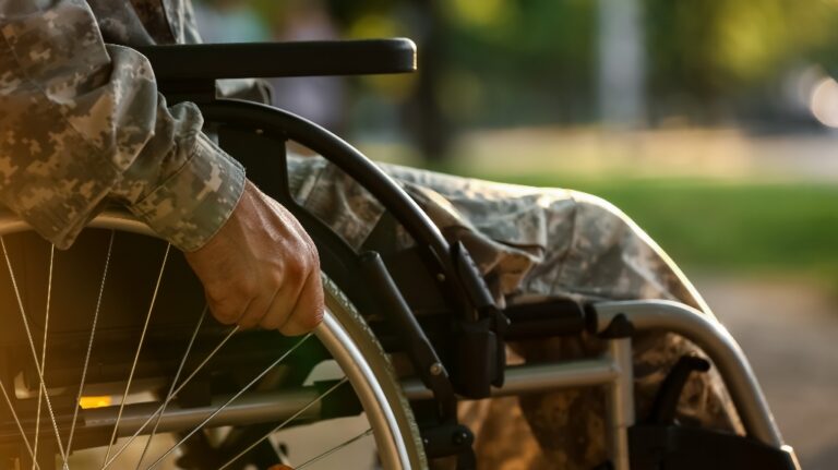 Young soldier in wheelchair outdoors