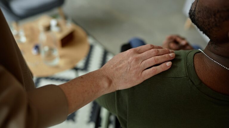 Woman is touching veteran shoulder